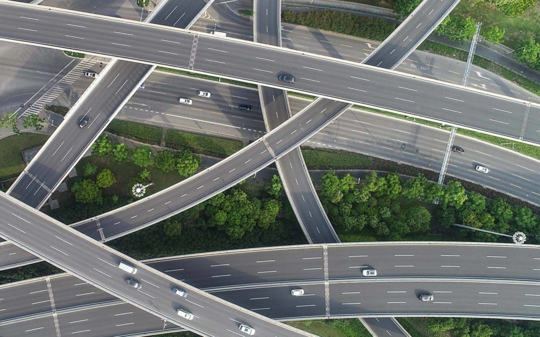 Aerial view of a highway system with cars on the road