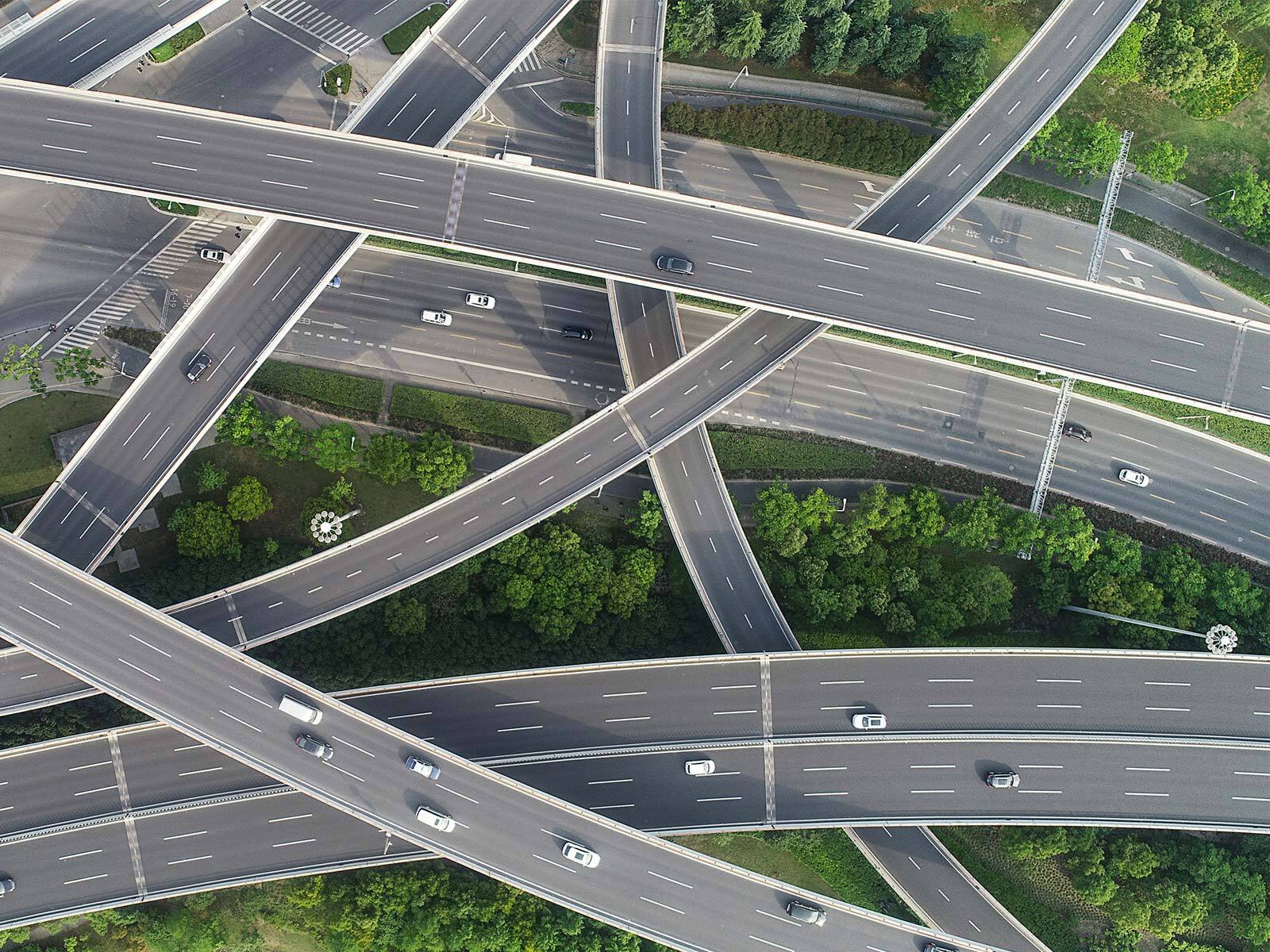 Aerial view of a highway system with cars on the road