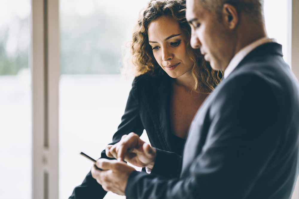 man- women- showing phone screen